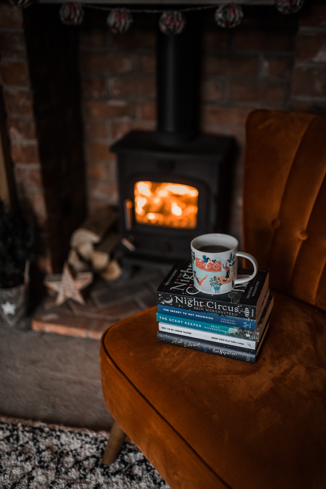 My top 10 reads of 2020 - Stack of books beside the fire