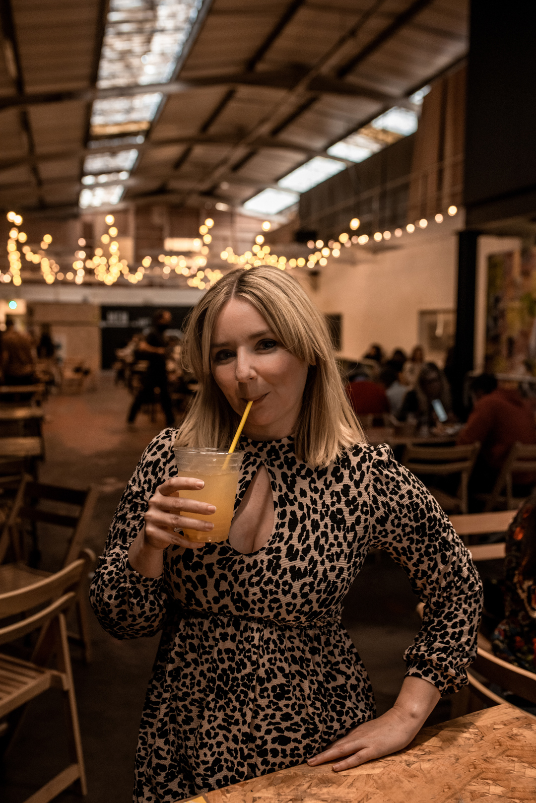 Bustler Market - Beth Anne sips a cocktail